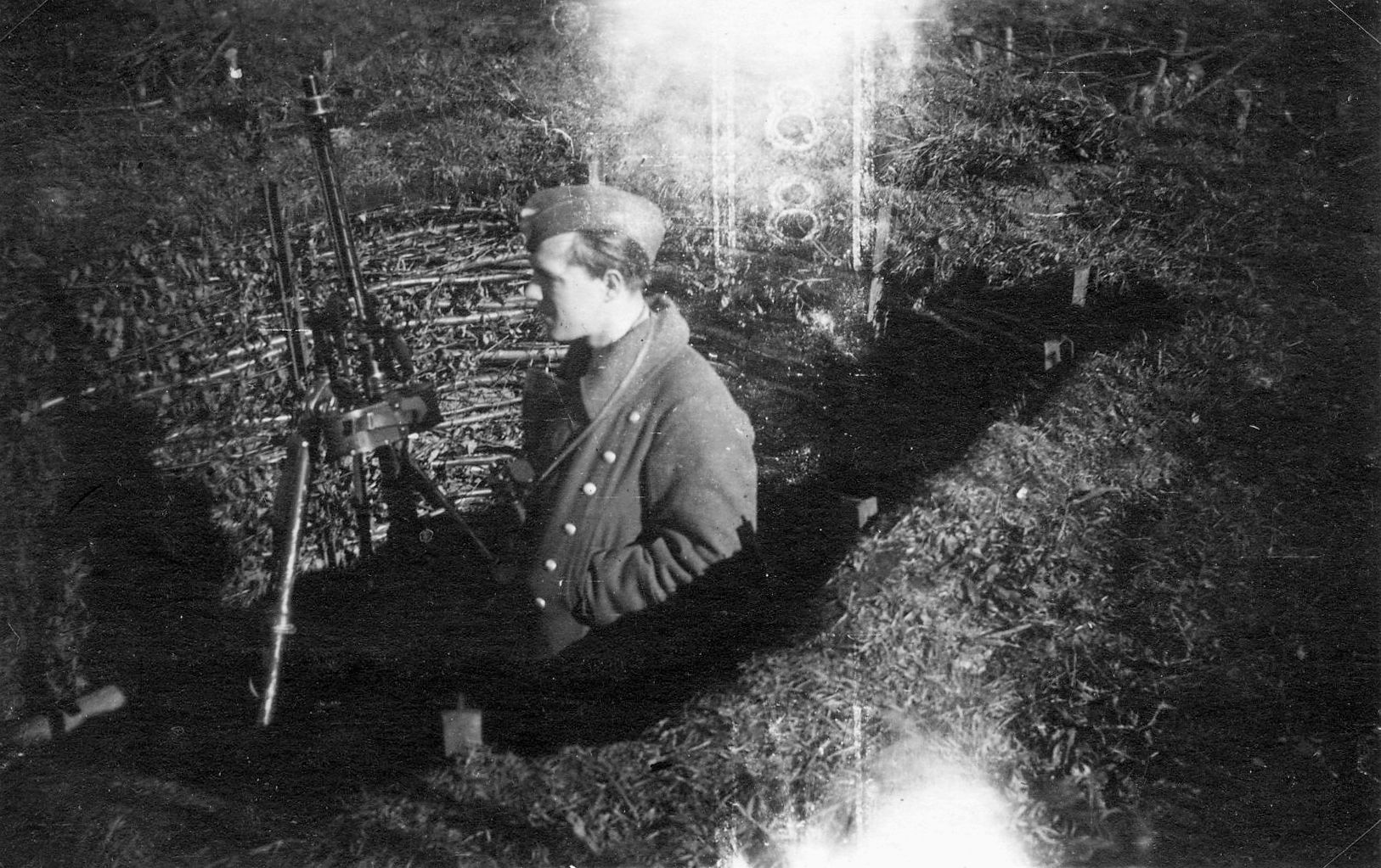 Cpl. Paul. Gustloff, who worked as a stevedore on the docks of Hamburg before the war, stands holding an MG-15 machine gun. Gustloff was later killed in action.