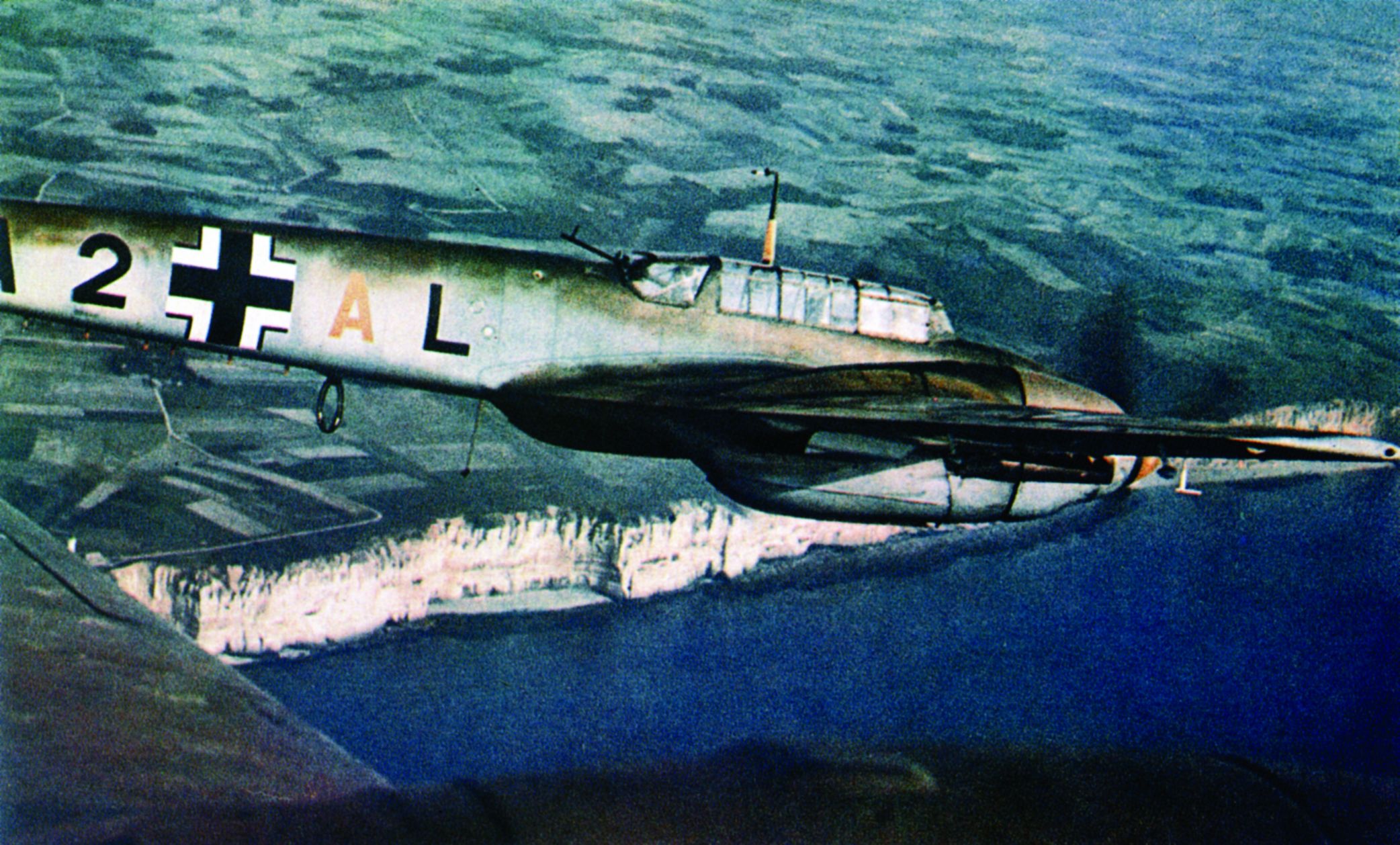 Flying above the famed white cliffs of Dover and the English Channel, a twin-engine Messerschmitt Me-110 of the Luftwaffe provides escort duty to German bombers.