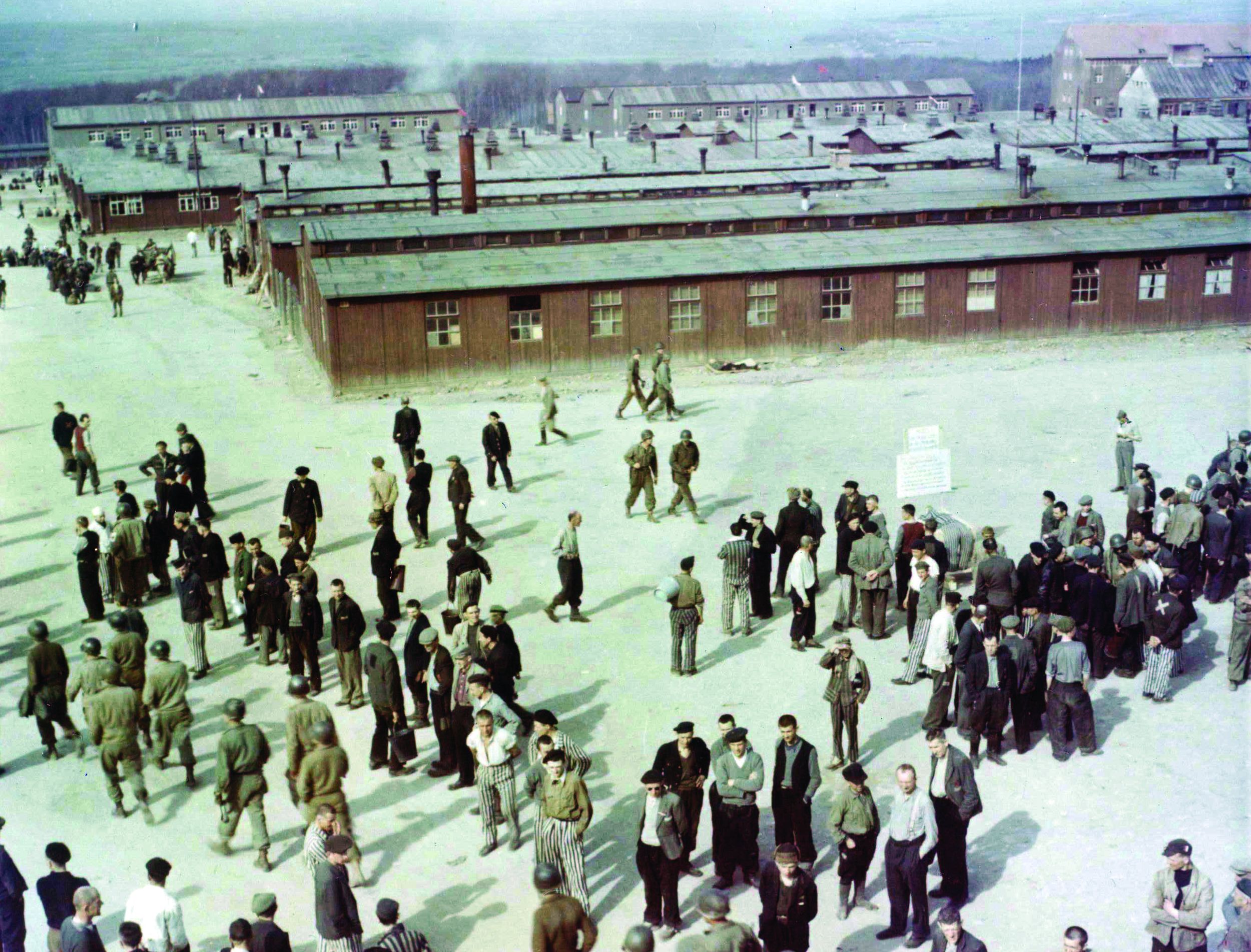 Waiting for transportation to Displaced Person Camps, former prisoners of Buchenwald who are able to walk mill around in the compound. Ultimately, they would be repatriated. This photo was taken from the guard tower near the main gate, which dominated the entire camp. (National Archives)