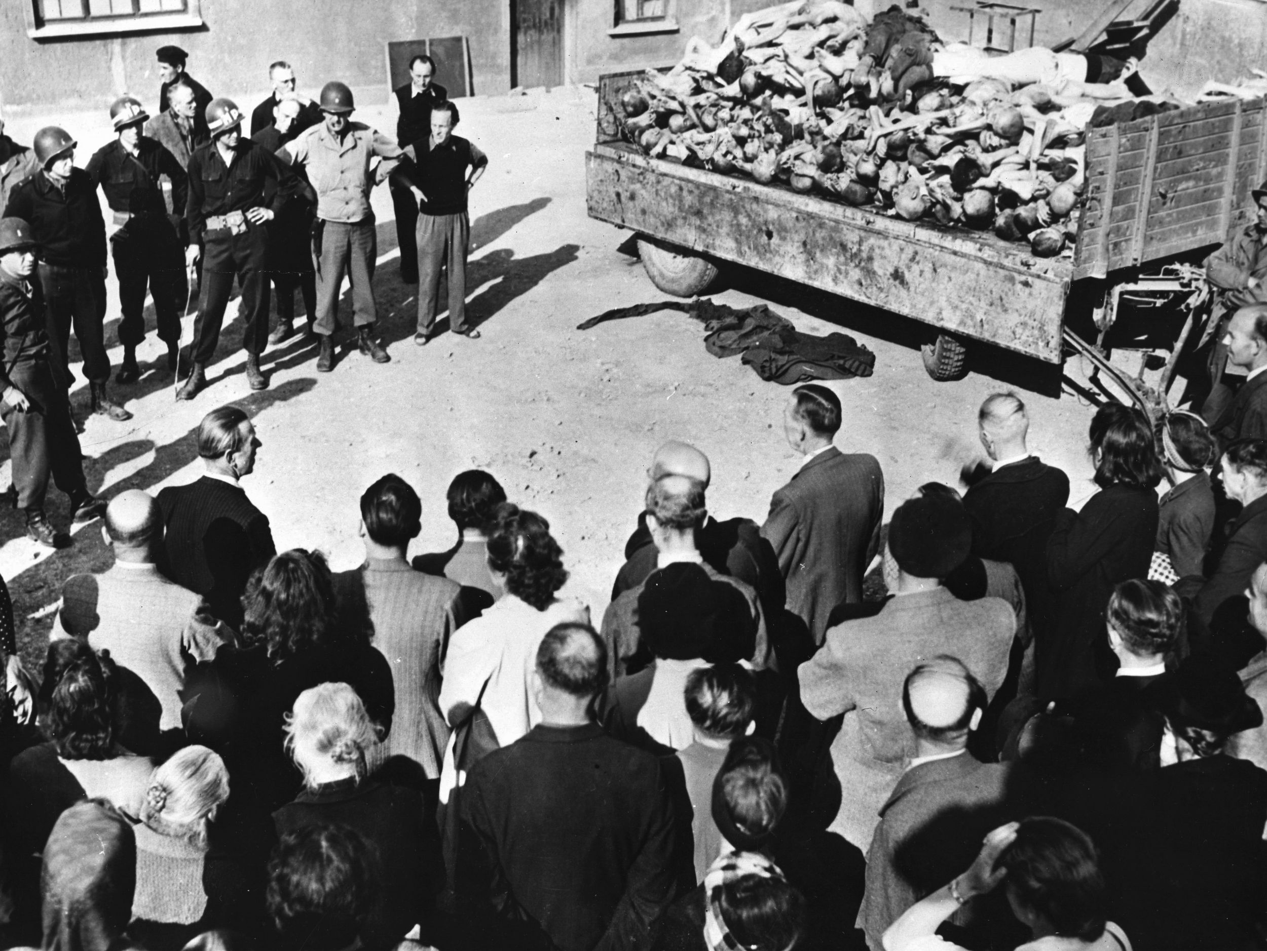 German civilians are forced to view the stacked bodies of dead Buchenwald inmates following the liberation of the camp. Some of the residents of nearby towns asserted that they were completely unaware of the atrocities taking place so close to their homes. (National Archives)