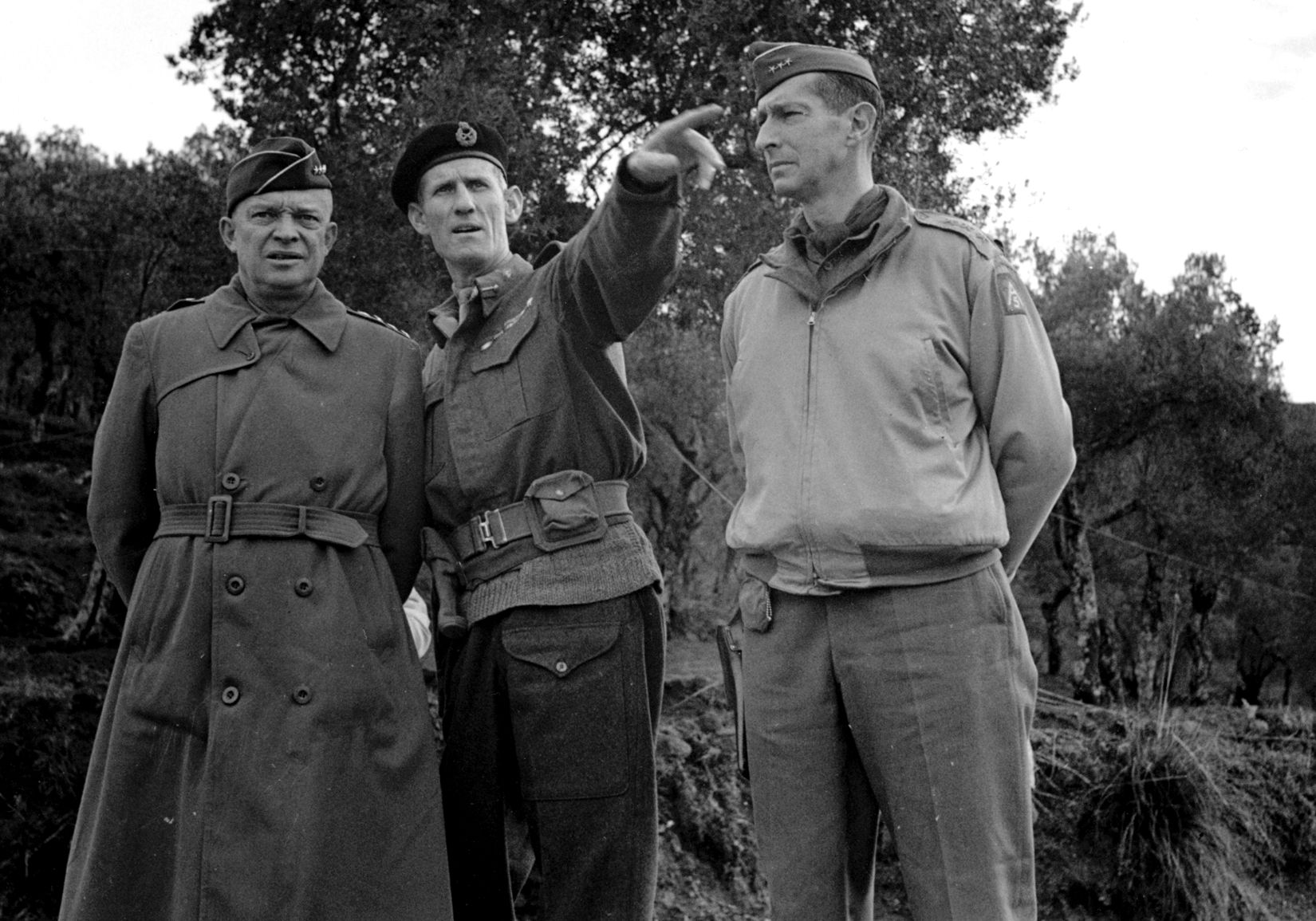Lieutenant General Sir Richard McCreery (center), commander of the British X Corps, gestures during conversation with General Dwight D. Eisenhower (left), supreme Allied commander in the Mediterranean Theater, and General Mark Clark (right), commander of the Allied Fifth Army, during a meeting at San Martino on December 23, 1943.