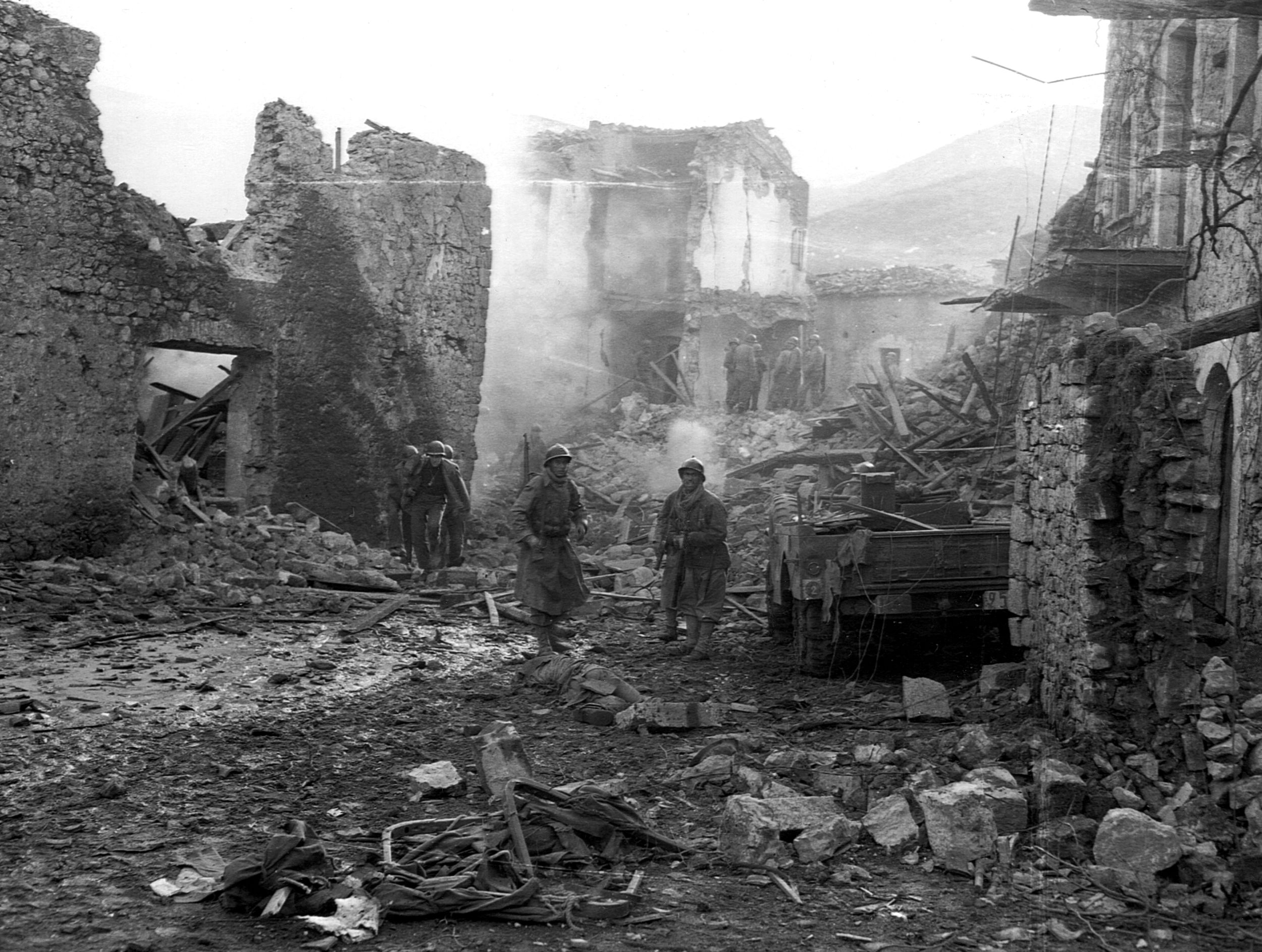 As the Italian Campaign wore on, the Luftwaffe appeared in force on fewer and fewer occasions. Here, however, debris still smolders in the streets of a town bombed and strafed by German aircraft moments before.