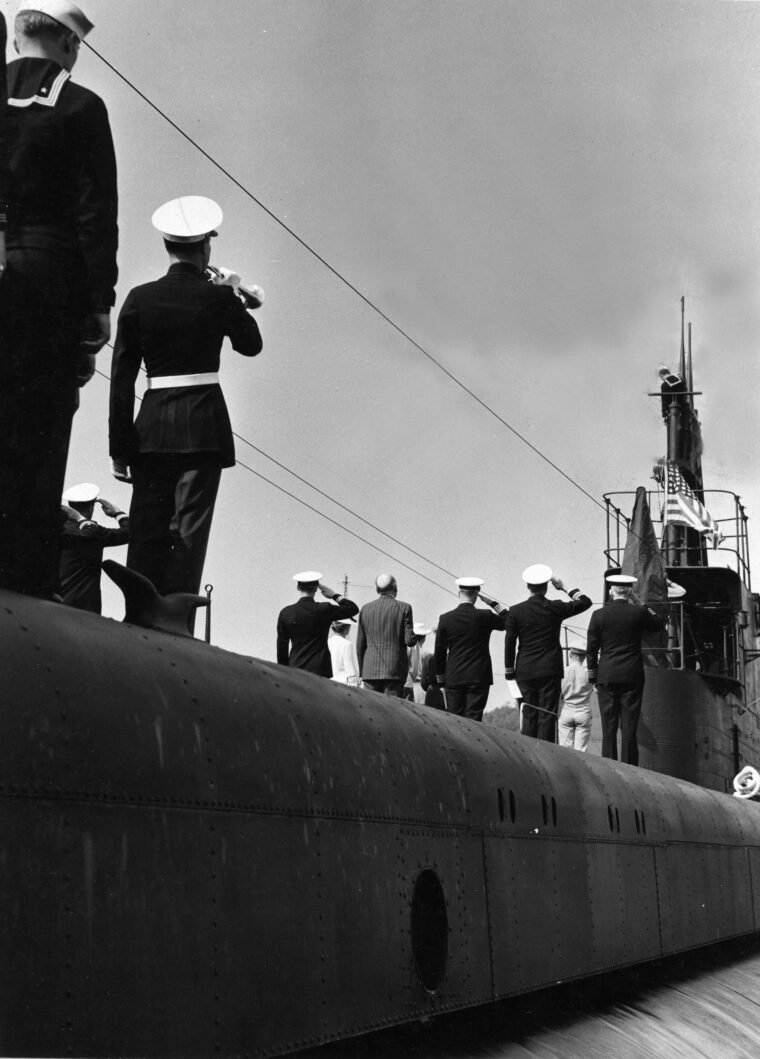 Officers salute as a bugler plays during the commissioning of the submarine USS Dace at New London, Connecticut, on July 21, 1943. Dace went on to compile an impressive wartime record.