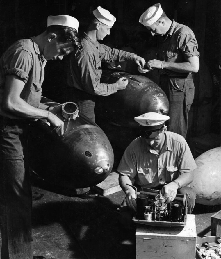 The warheads of several American torpedoes are given final checks prior to loading aboard a U.S. submarine at its New London, Connecticut, base in July 1943.