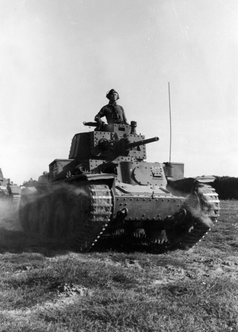 Its commander riding in an open hatch, a German tank moves toward the front.