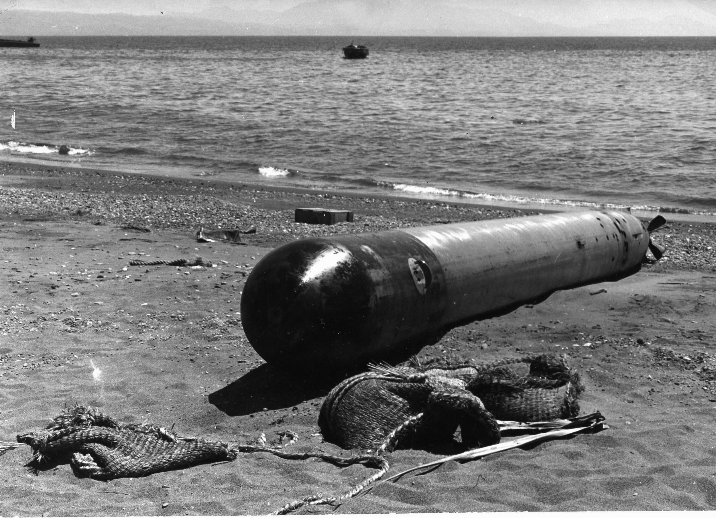 Apparently fired by a Japanese submarine under attack by U.S. forces, this Japanese torpedo failed to find a target or to explode and came to rest on the beach near the entrance to a U.S. naval facility at Guadalcanal.