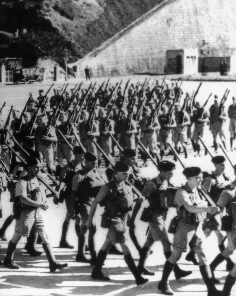 After landing in Hong Kong, Canadian troops march to join the garrison and continue training. The political wrangling that preceded the deployment of Canadian troops to Hong Kong is questioned to this day. 