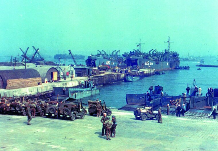 Soldiers drive jeeps onto waiting LCTs at a British port in preparation for the Normandy landings on June 6, 1944.
