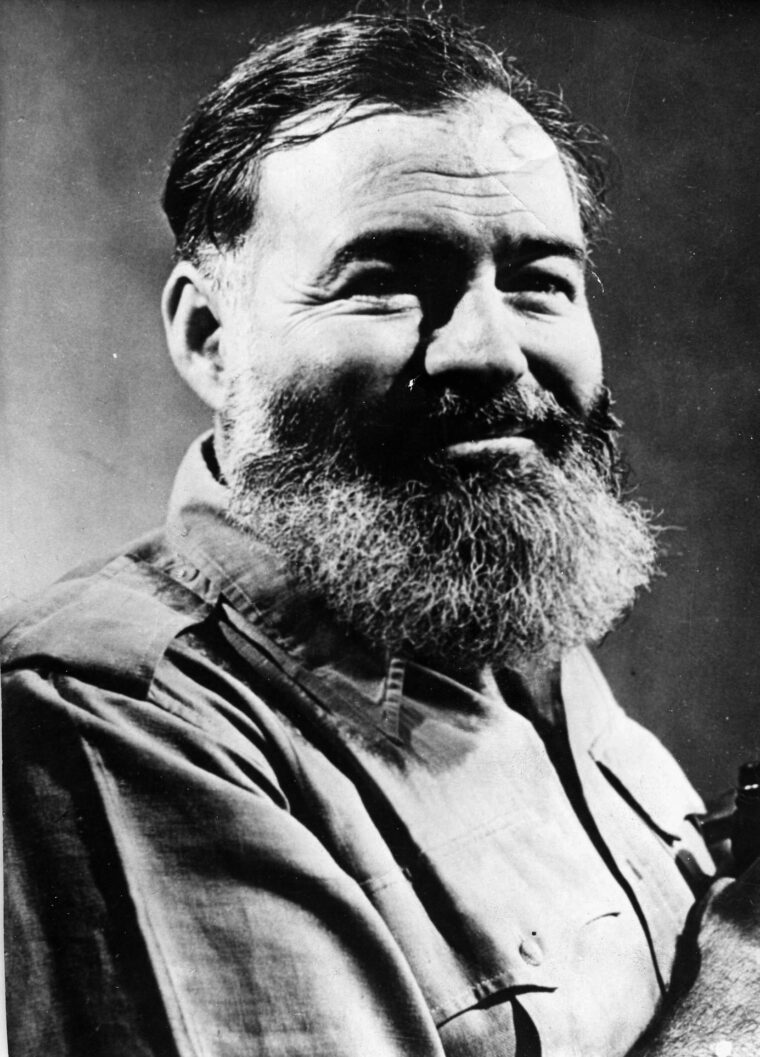 Sporting his characteristic heavy beard, author Ernest Hemingway posed for a photographer in this undated photograph. 