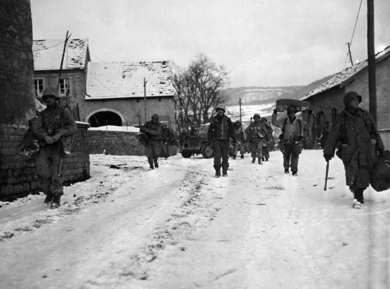On January 21, 1945, soldiers of the U.S. 8th Infantry Regiment, 4th Infantry Division move cautiously through the town of Moesdorf, Luxembourg. (All photos: National Archives)