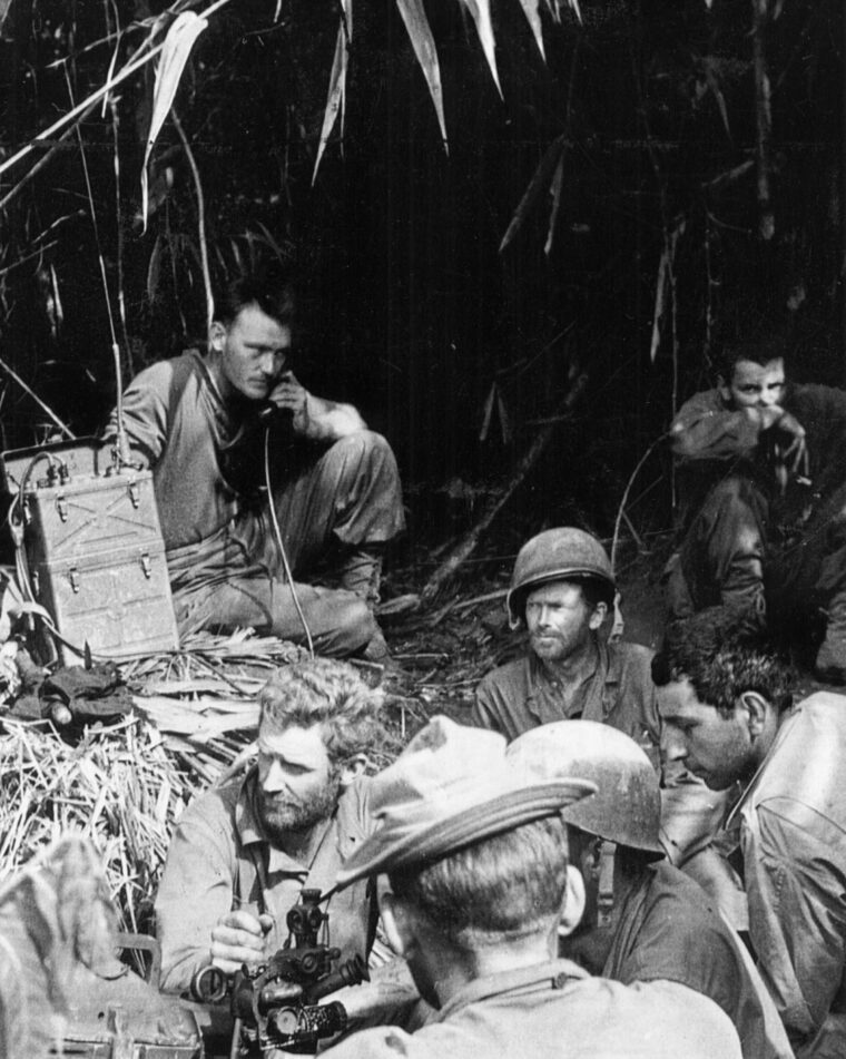 Going over final instructions, a squad of Marauders prepares to move out on a mission to silence a Japanese machine gun position that has been impeding their progress.