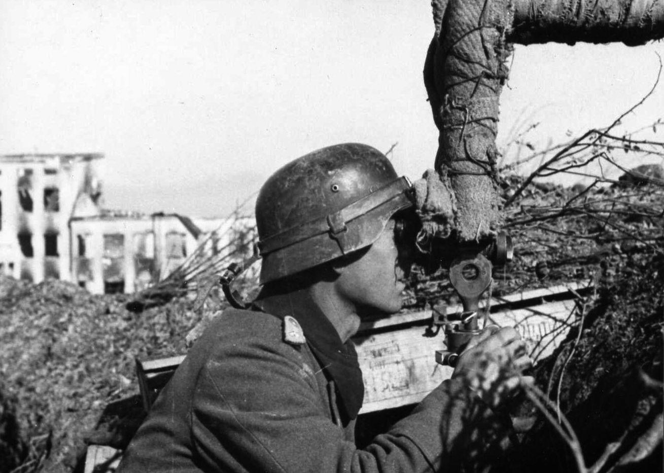 During the catastrophic German defeat at Stalingrad, a Wehrmacht soldier peers from cover through a telescopic viewer. The distant Soviet Red Army tightened the ring of steel around the Germans at Stalingrad until they capitulated in February 1943. 