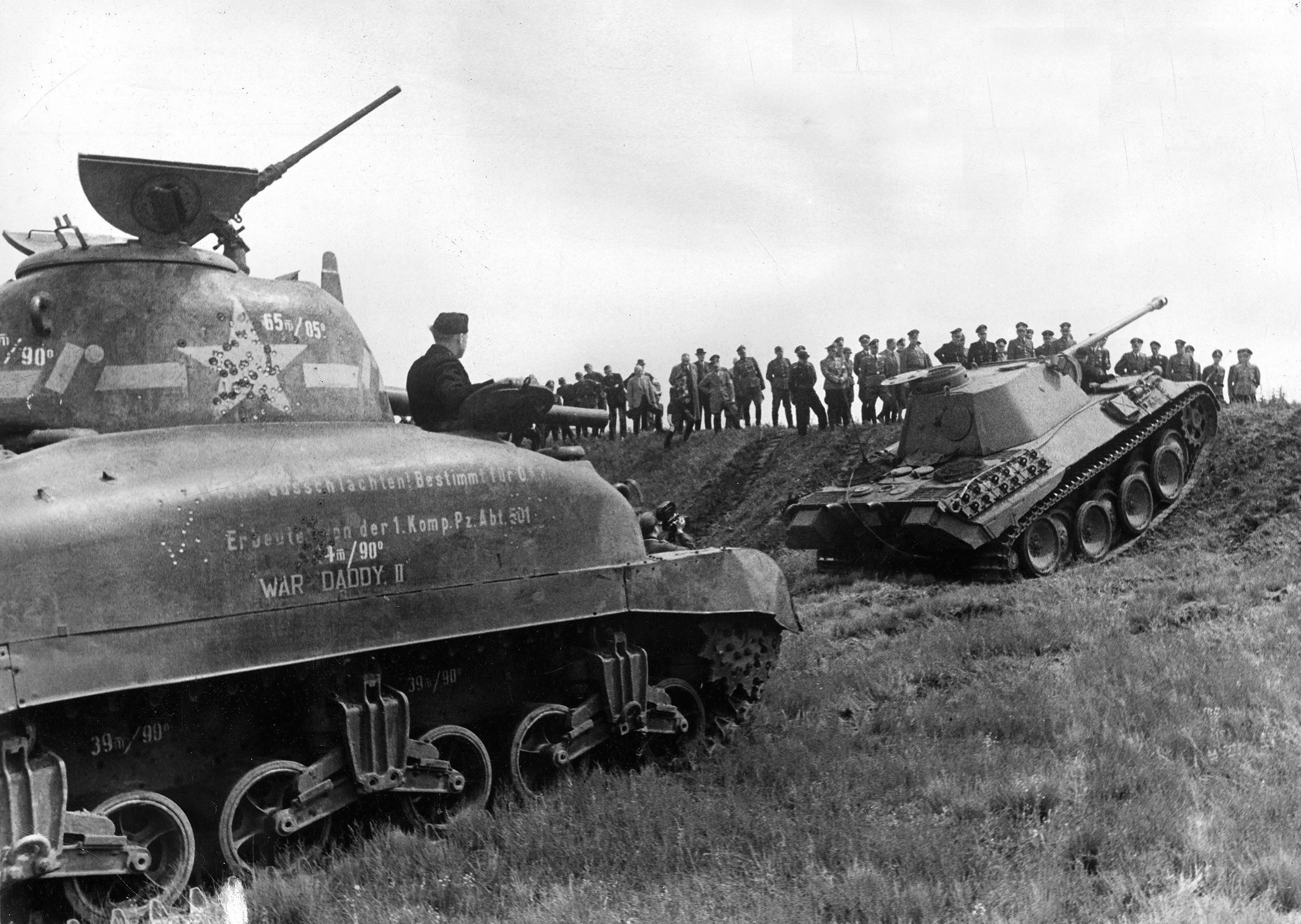 “War Daddy II,” a captured American Sherman (left) is tested against a German Panther and other tanks. After testing by the German Army Weapons Office, some captured tanks were put on display while others were put into service  against their original owners. 