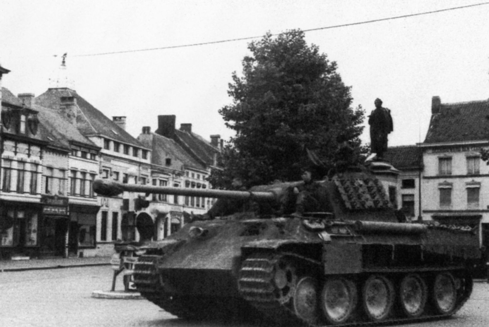 Pausing momentarily in the square of a deserted French town, a Panther medium tank and its 75mm high velocity cannon present a menacing profile. The Panther was designed by German engineers in response to the hugely successful Soviet T-34. (National Archives)