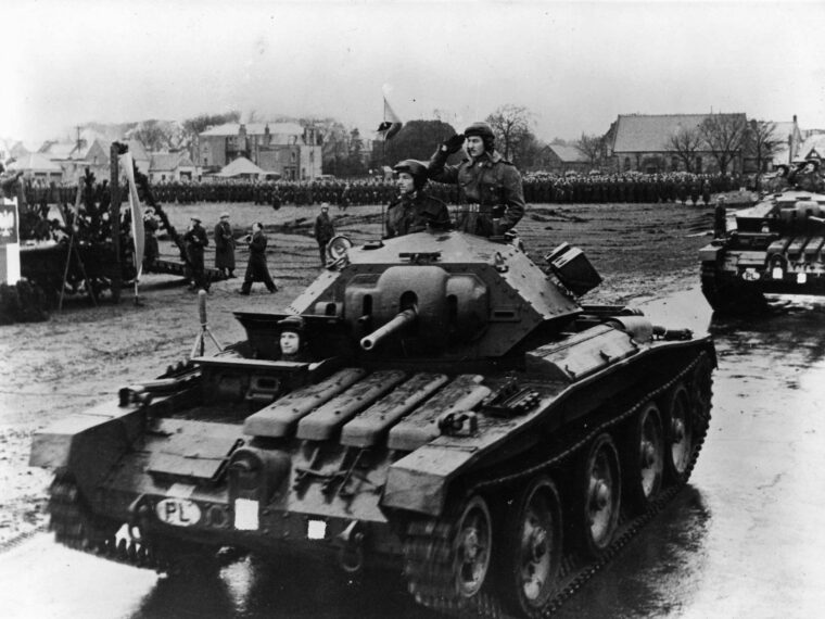 A Polish tank commander salutes as his unit passes in review during a ceremony in Scotland prior to deployment to Normandy. Polish units made a significant contribution to the Allied offensive in Western Europe. (National Archives)