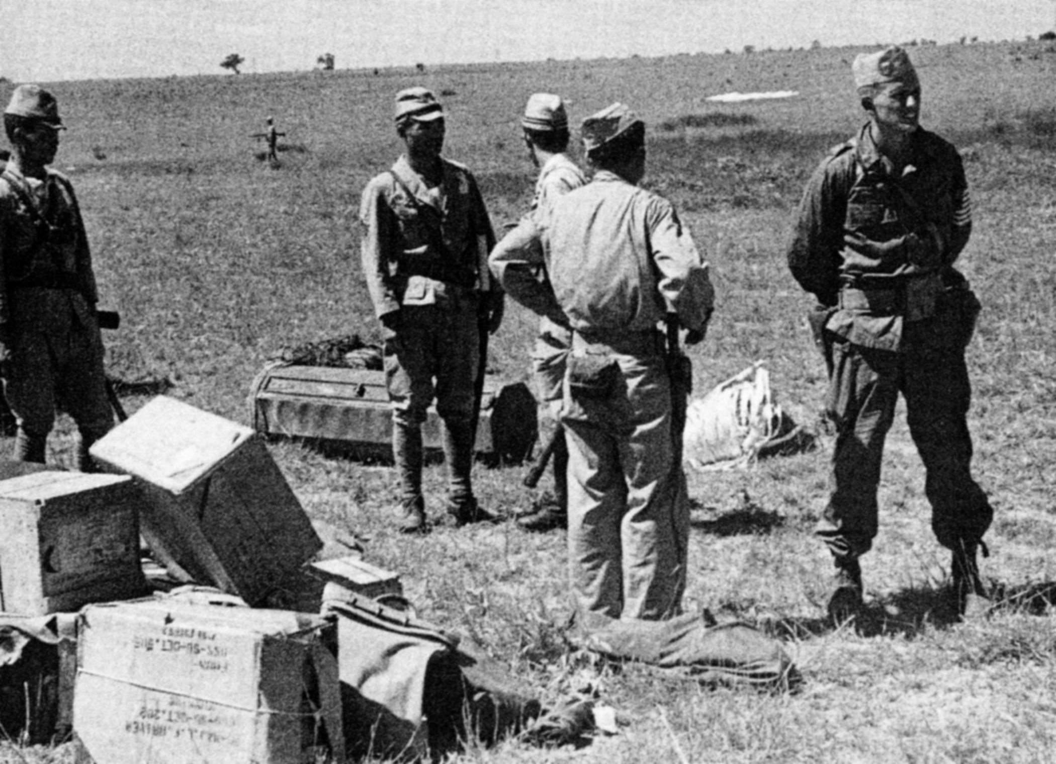 Minutes after landing on the island of Hainan off the coast of China, an OSS prisoner of war rescue team confers with a Japanese lieutenant. While his men gathered supplies, Captain John Singlaub refused to negotiate with the startled officer, saying he was not senior enough.