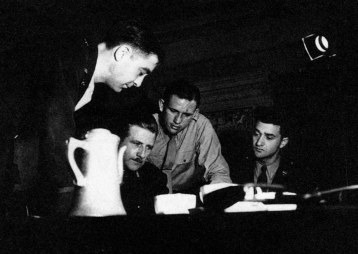 Before parachuting into occupied France, an OSS Jedburgh team is briefed on numerous topics. Agent John K. Singlaub is shown second from right. (Photos courtesy of John Singlaub)