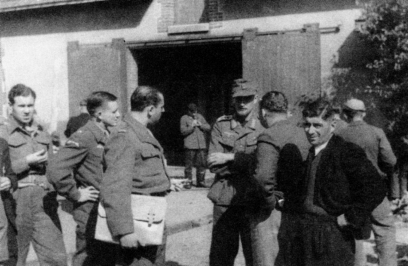 OSS operatives interrogate a German prisoner recently captured by French partisans known as Maquis. John Singlaub is at the left with his hand on his hip. (Photos courtesy of John Singlaub)