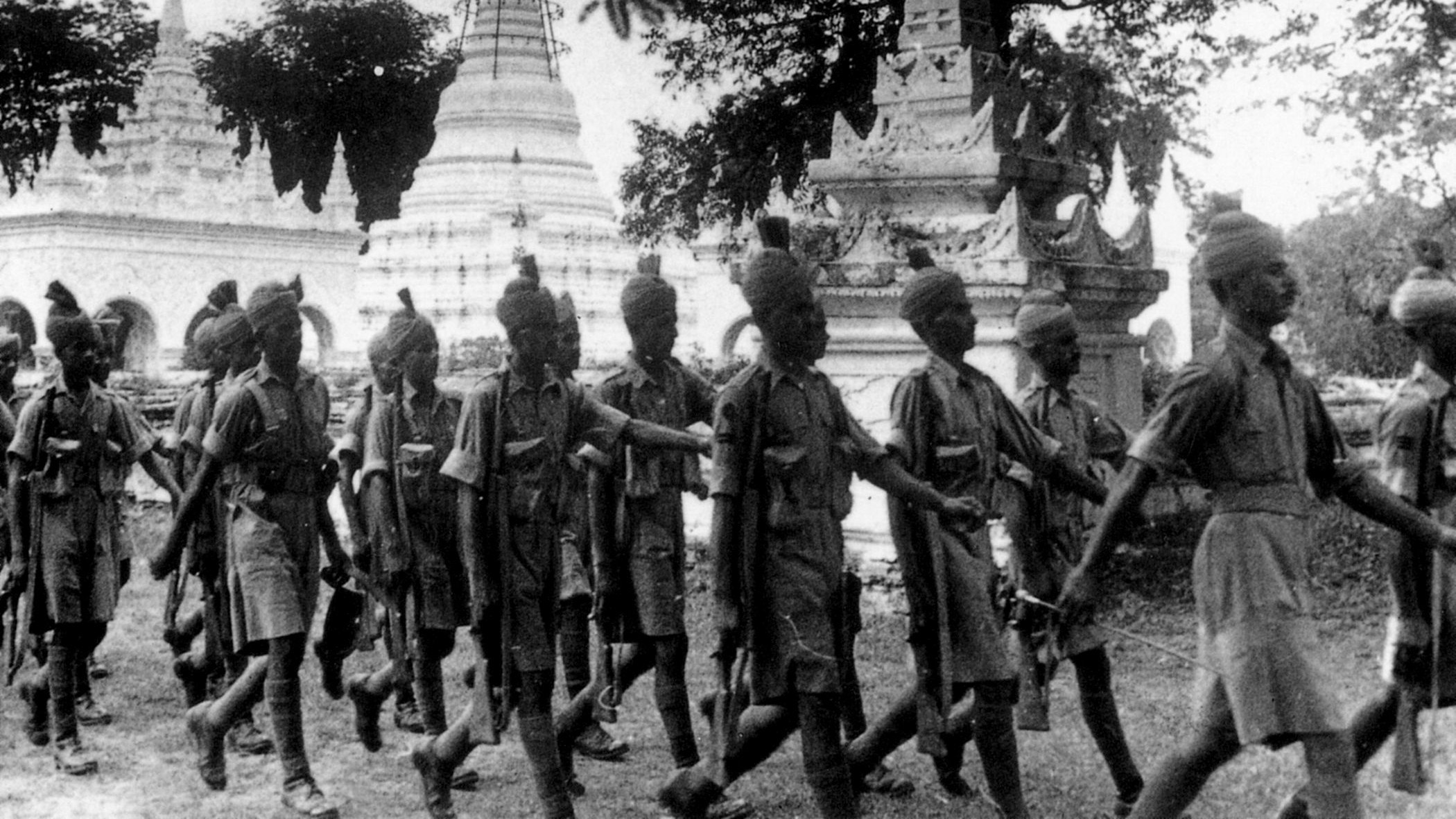 Preparing for an invasion by the Japanese, Indian troops, which comprised a large number of the British Commonwealth forces in Burma, march past a pagoda toward defensive positions. (Imperial War Museum)
