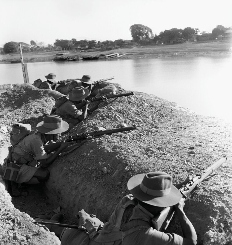 British Commonwealth troops crouch in a trench along the banks of the Sittang River in Burma as they await the onslaught of the Japanese. Enemy machine-gun fire took a fearful toll on the defenders from a distance of only 250 yards, and the Commonwealth soldiers absorbed heavy losses as the Japanese continued their advance on Rangoon. (© Magnum Photos)