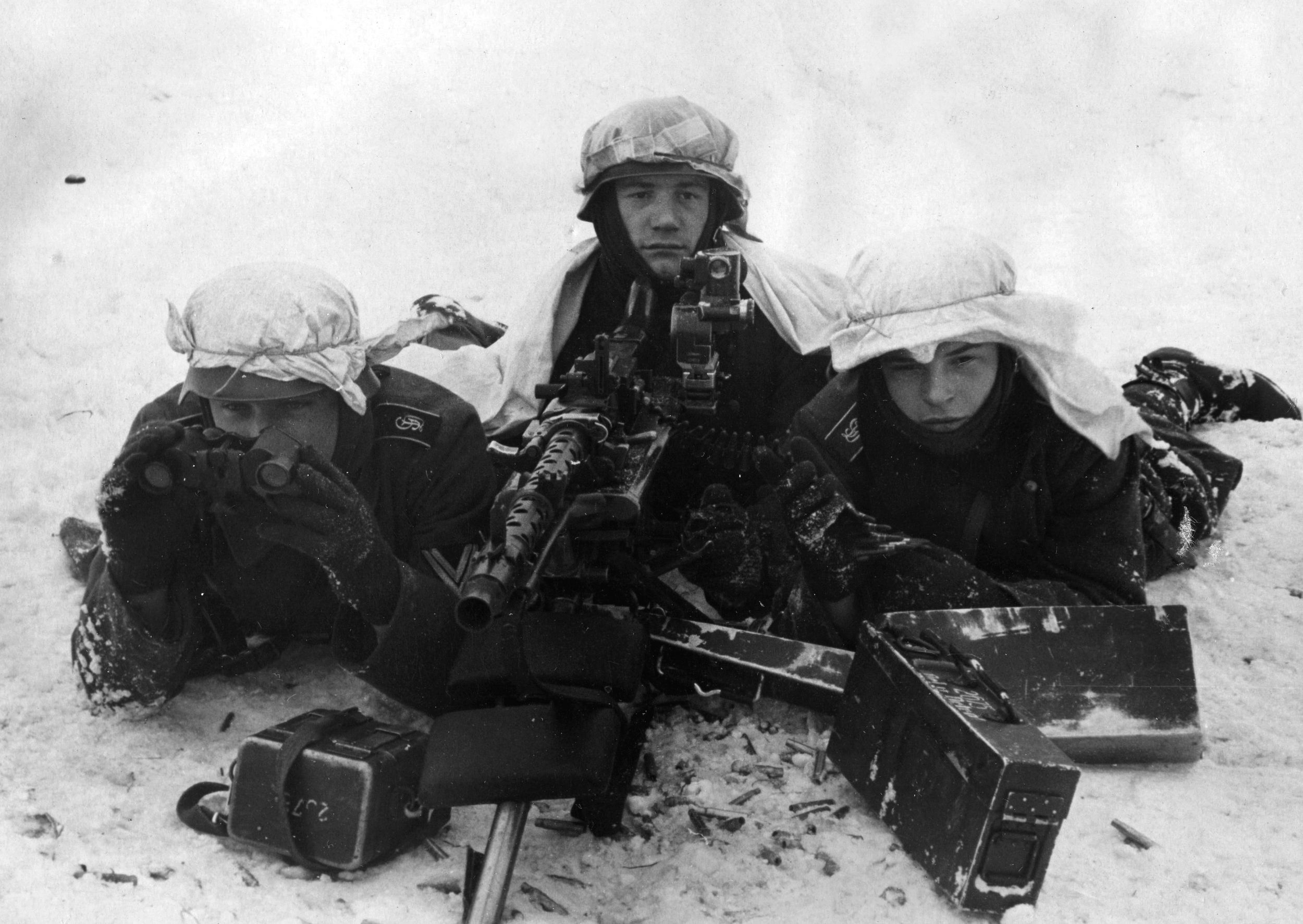 A German machine gun crew of the Grossdeutschland (Greater Germany) Regiment awaits a Red Army attack.  This trio appears to have commandeered white bedsheets for use as camouflage.