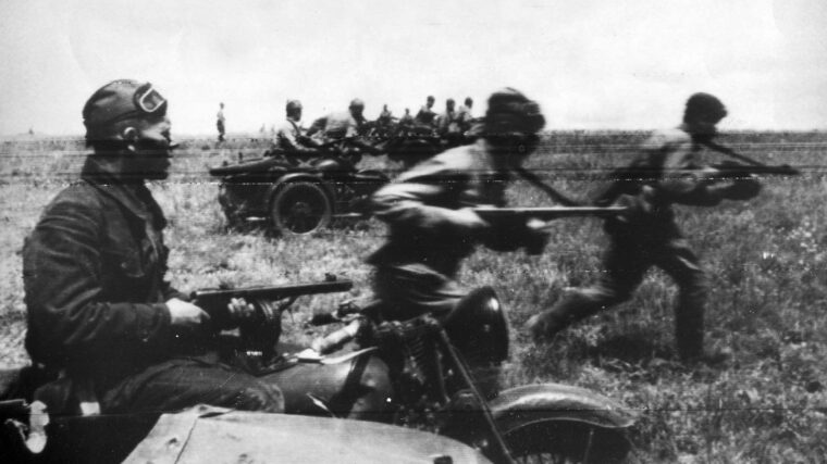 With infantry charging alongside, a motorcycle unit of the Red Army roars into action against German positions in July 1942. The submachine gun appears to be the weapon of choice for these soldiers.