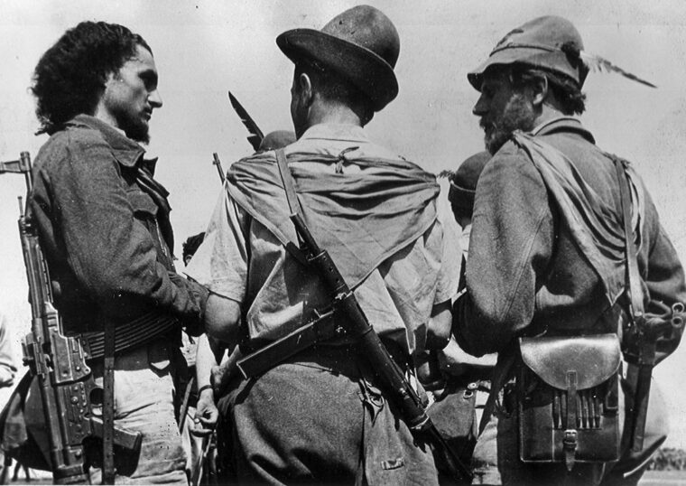 On June 16, 1945, Italian partisans gather at a soccer field in the Friuli District of Italy near Venice. The partisans had been instructed to turn in their arms, and they complied—reluctantly in some cases.