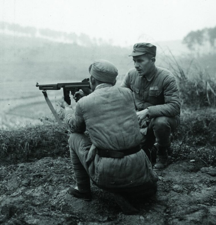 Under the watchful eye of Captain Walter Mansfield, a Chinese soldier masters the firing of a Thompson submachine gun on January 15, 1945.