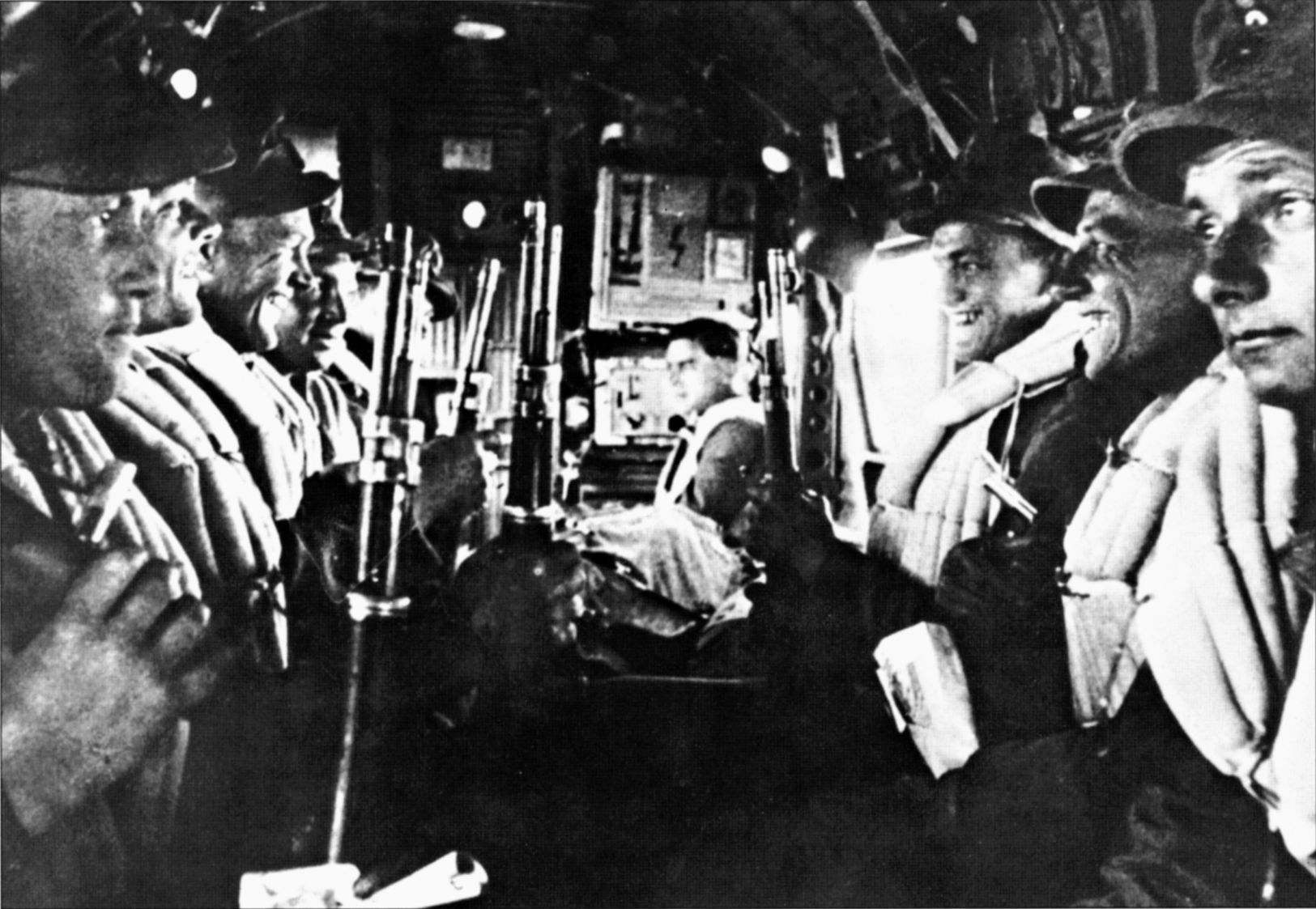 German airborne troops are seated inside their Ju-52 transport plane en route to drop zones on  Crete. The German paratroopers suffered horrendous casualties during the invasion but eventually secured the island after several days of hard fighting. 