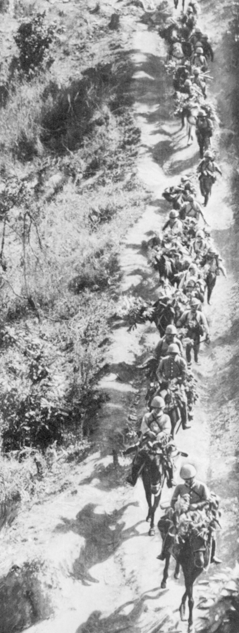 Japanese cavalrymen, some without mounts, traverse a dusty road during their advance toward Kohima and Imphal in 1944. Losses among the horses were said to be greater than two-thirds.