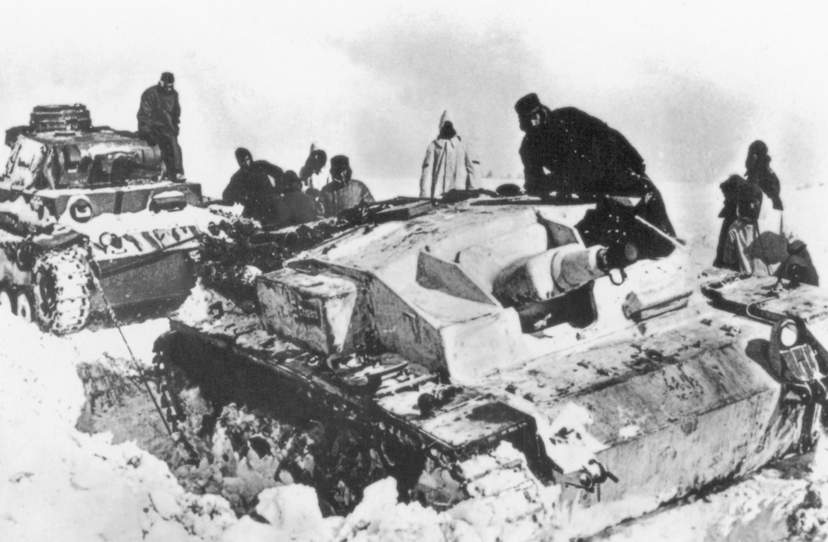 German troops not only battled the Soviets but the cruel elements as well. Here, a German tank drags an immobilized assault gun from a snowdrift.