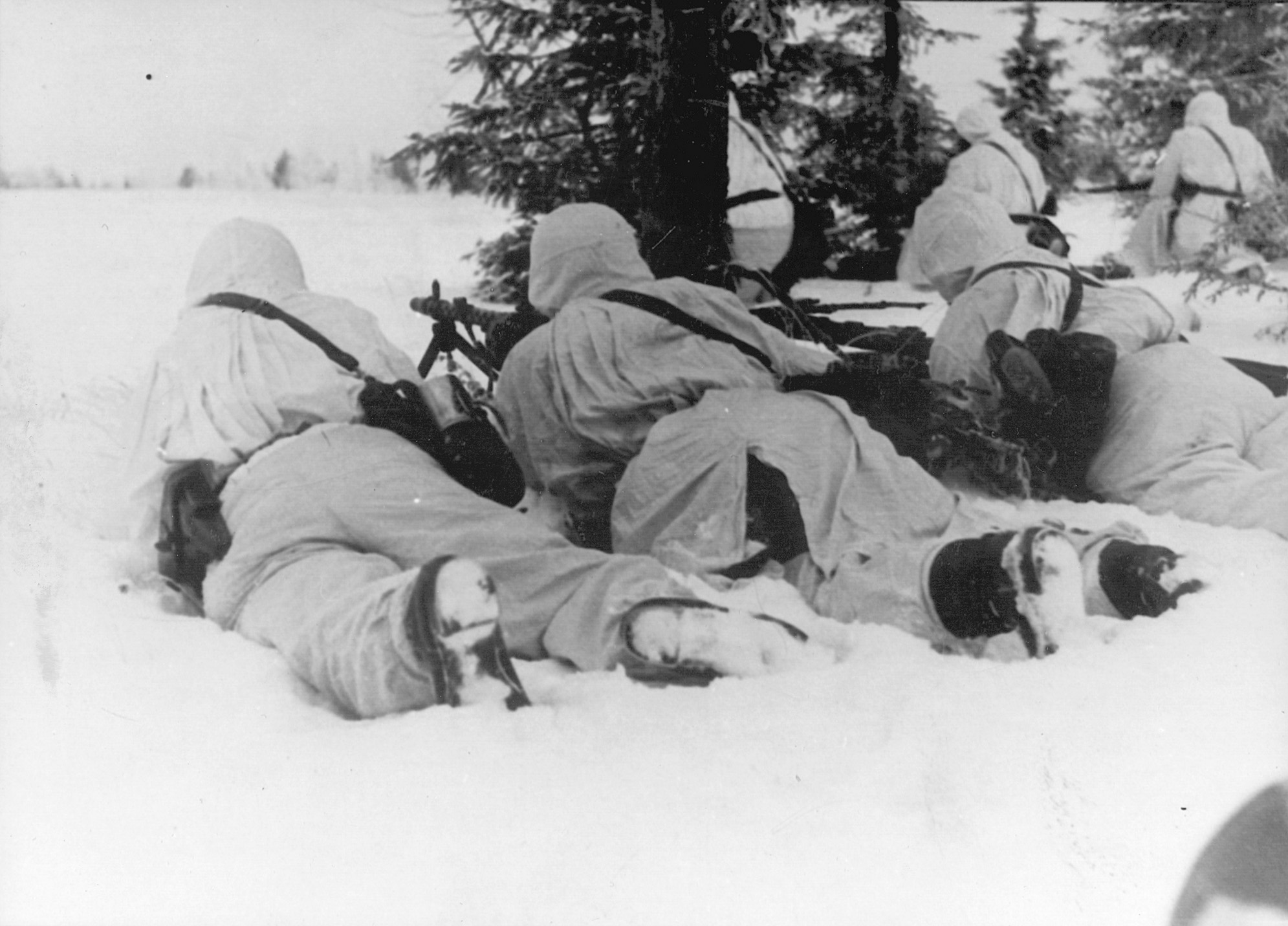 German machine gunners, camouflaged for winter warfare, scan an open field for targets. The vanguard of the Soviet offensive near Rzhev ran into a determined defense mounted by crack troops of the elite SS. 
