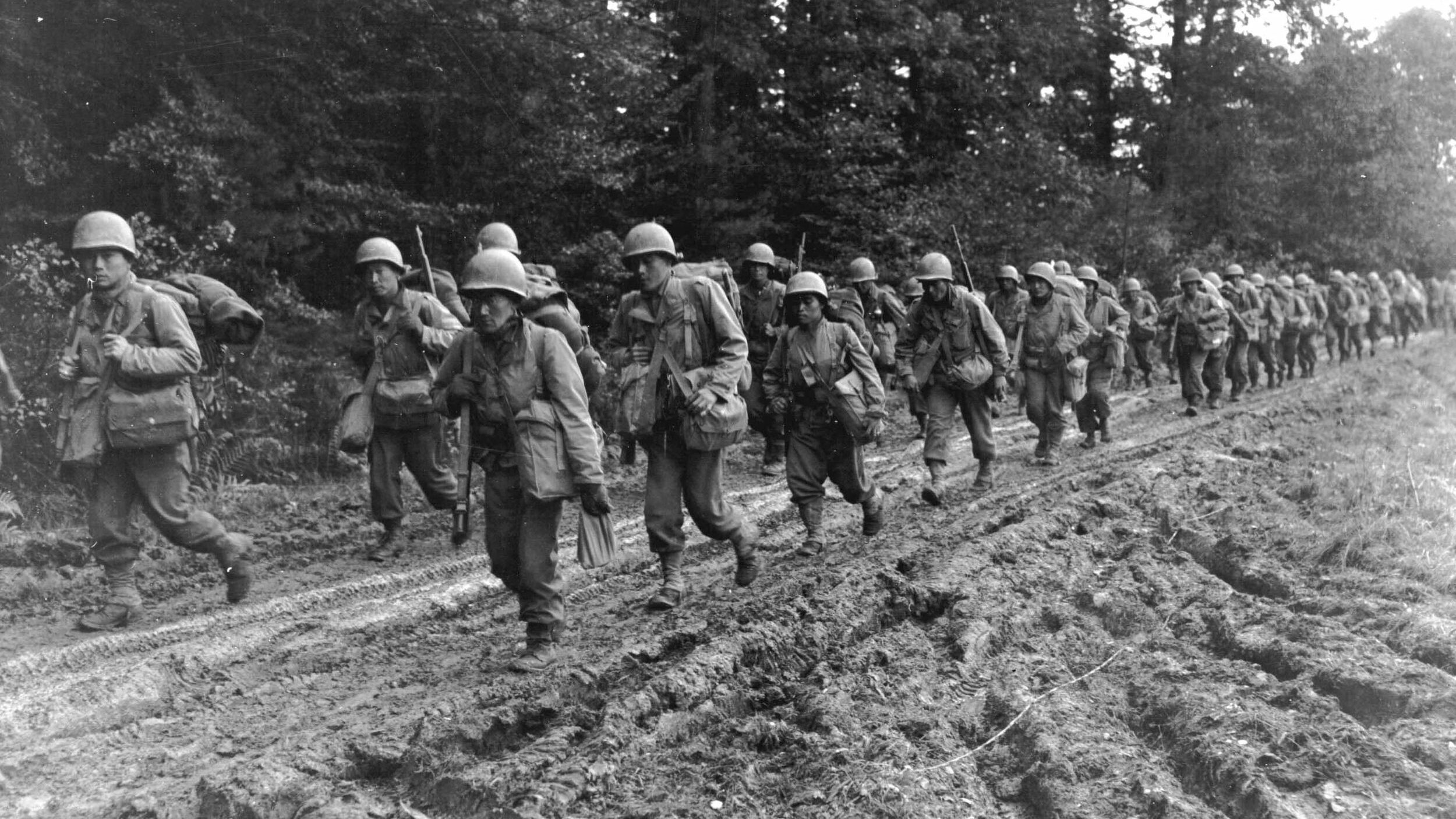 American soldiers of Japanese ancestry, these members of the 442nd Regimental Combat Team trudge down a road in France prior to their second deployment to Italy. The 442nd gained lasting fame during the Italian campaign and finished the war as one of the most highly decorated units of the U.S. Army.