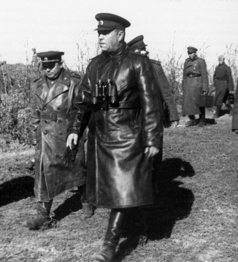 Soviet Marshal Georgi Zhukov, a commander of the Red Army units engaged at Kursk, strides to a meeting with subordinates. To his right is Aleksandr Vasilevsky, chief of the Soviet general staff. 
