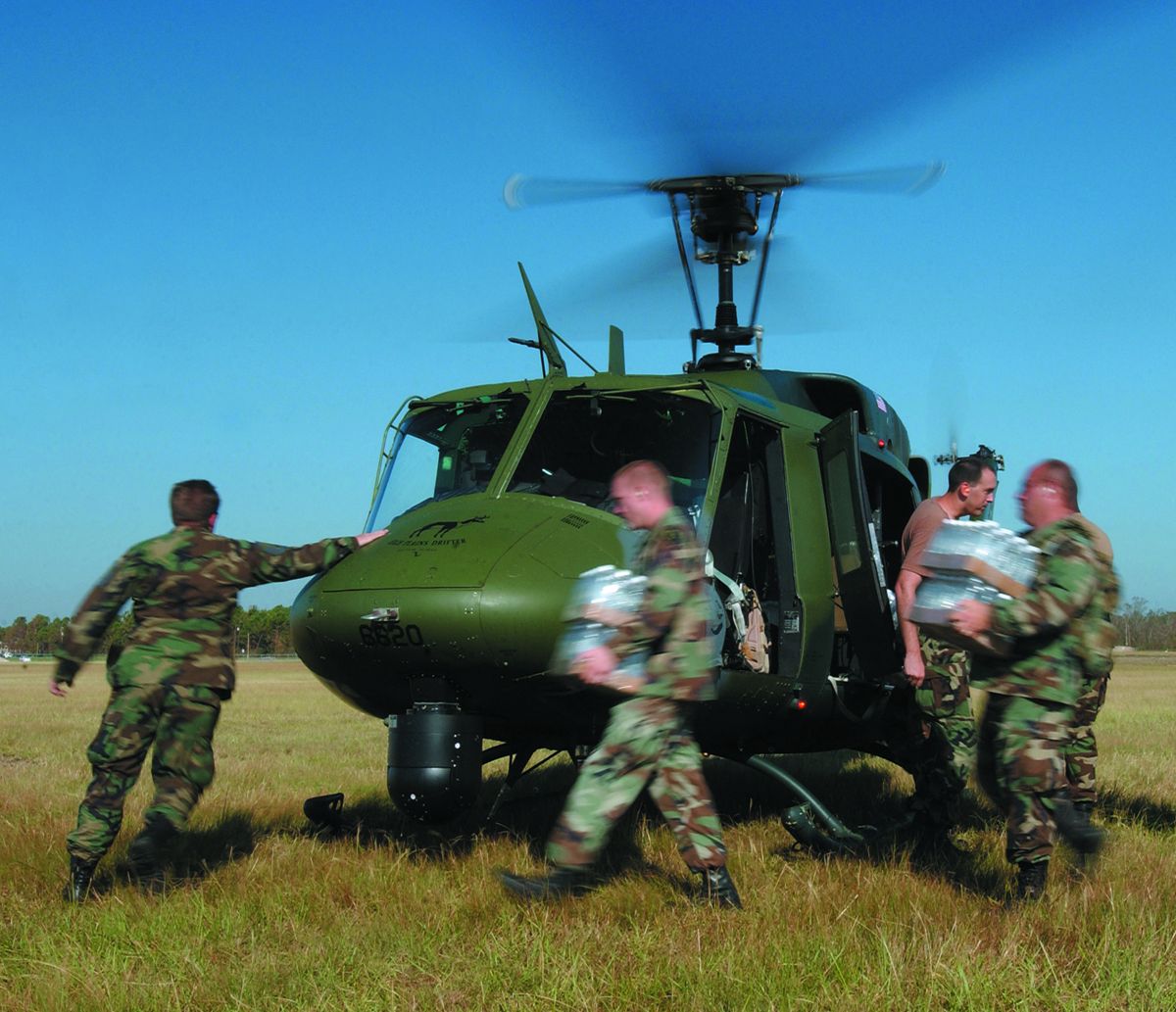 Members of Joint Task Force Katrina load precious water supplies onto a UH-1N Huey in Gulfport, Mississippi, after the disastrous 2005 hurricane.