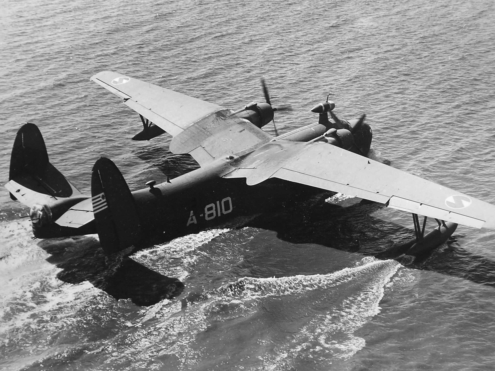 A U.S. Navy Martin PBM Mariner flying boat lands in calm Pacific waters. During the daring rescue of the SS Cape San Juan survivors, conditions were much different. The plane was eventually loaded with 55 passengers, including 48 men plucked from the water.