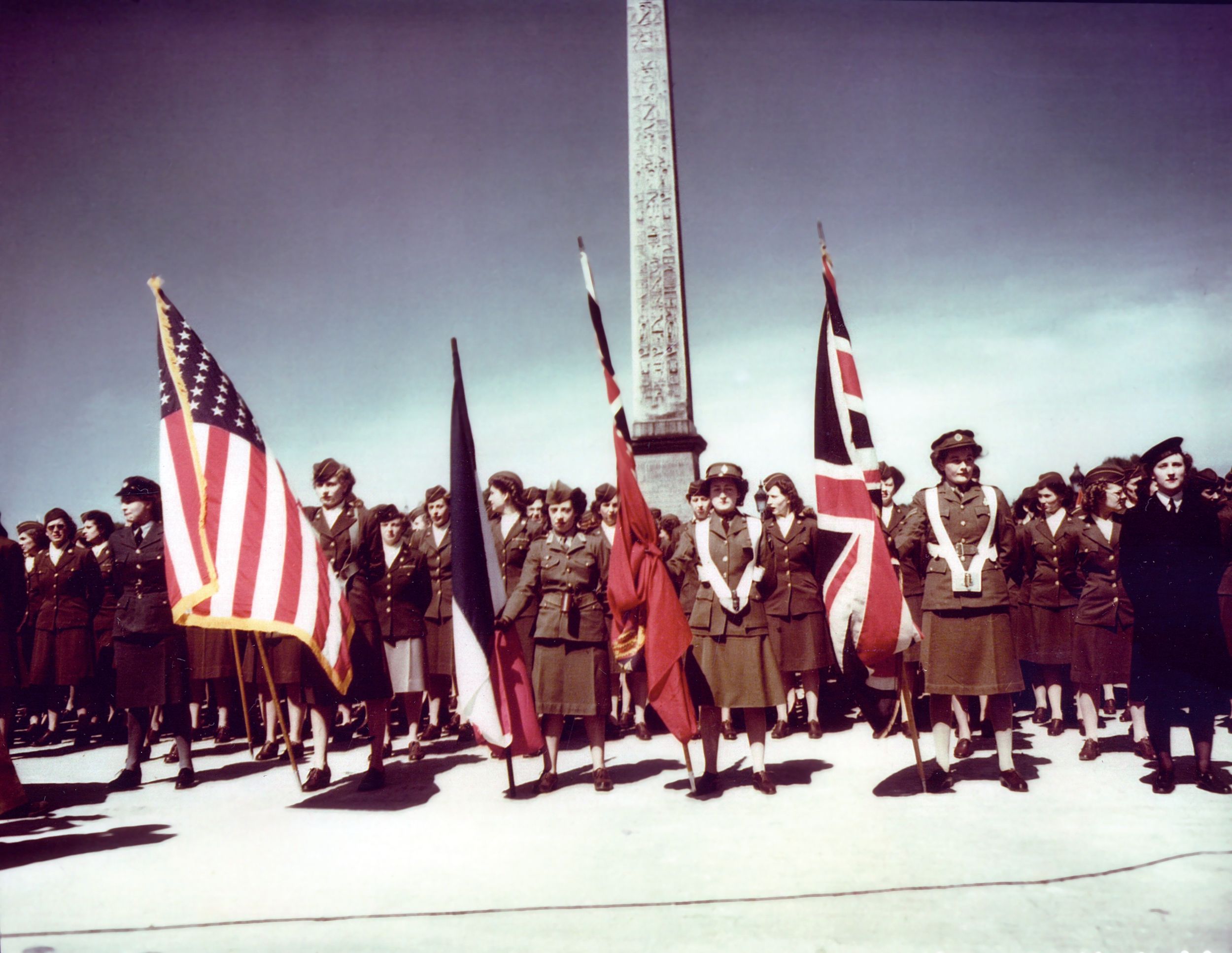 In front of the Obelisk of Luxor, American, French, Canadian and British WACs (Women’s Army Corps), prepare to parade down the Champs Elysees in honor of the WACs’ third anniversary.