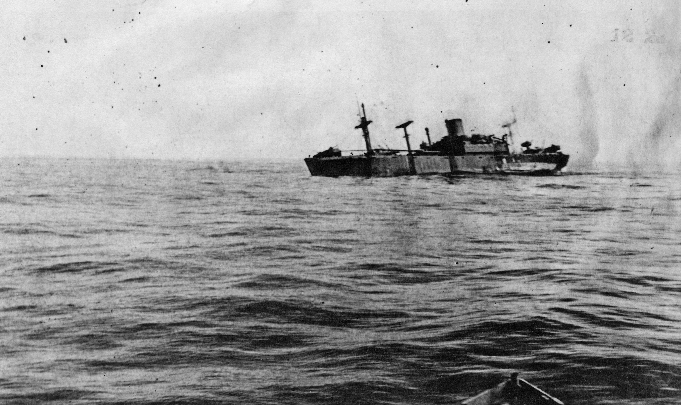 Photographed the day after it was attacked by the Japanese submarine I-21, the troopship SS Cape San Juan lists sharply to port. Soon after this photo was taken, the ship slipped beneath the waves.