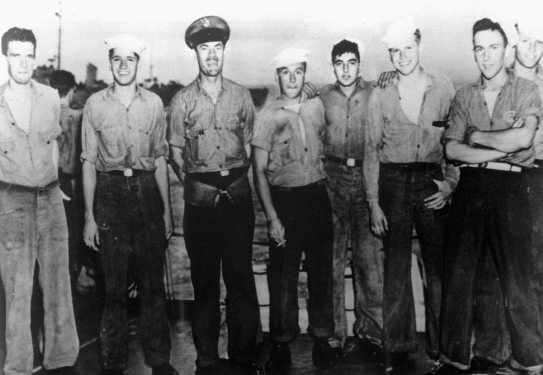 Crewmen of the destroyer escort Pillsbury are shown celebrating the capture of the submarine U-505. These men were members of the first boarding party to reach the German vessel.