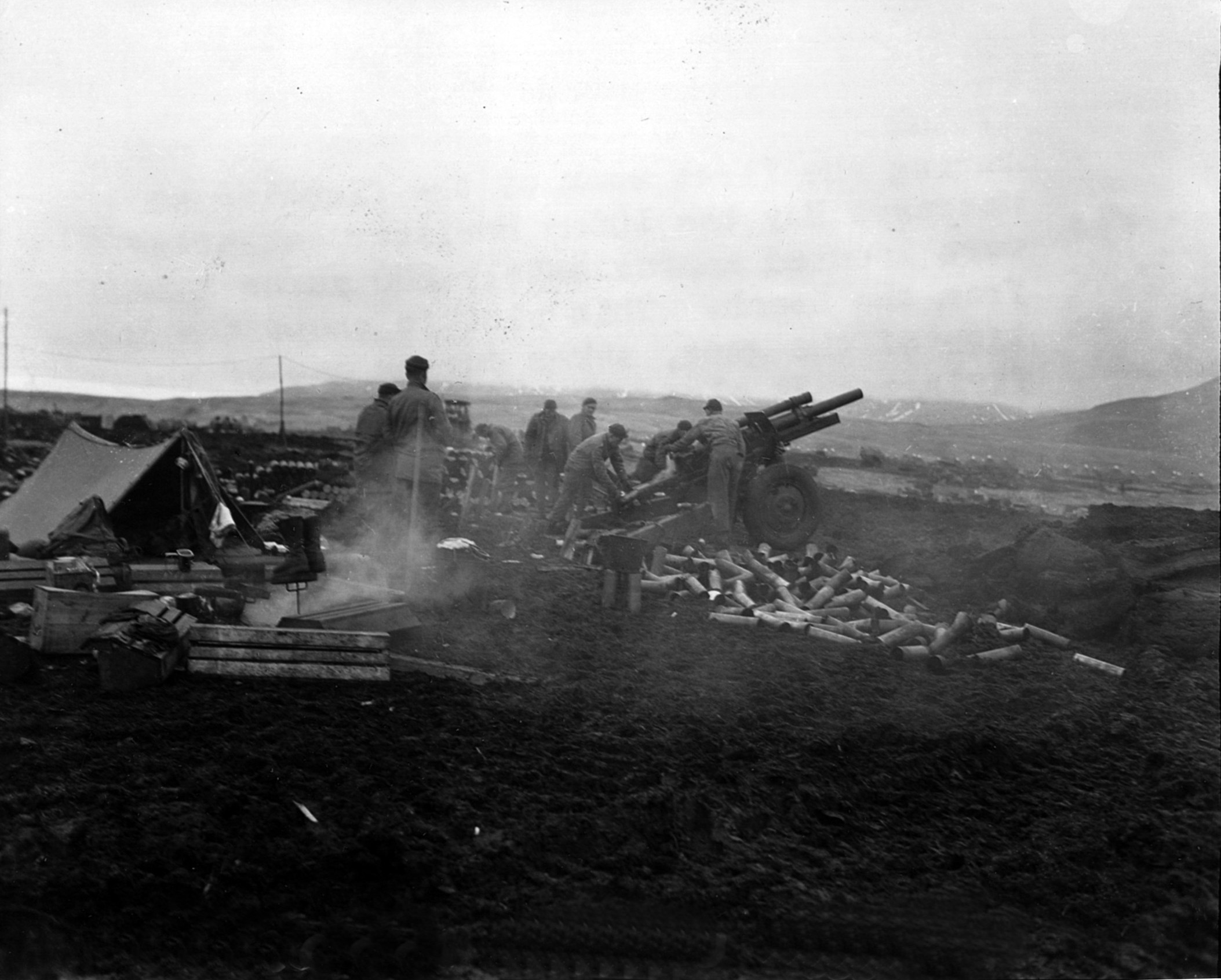 About 200 yards inland from a stormy beach on Attu, U.S. soldiers fire a 105mm howitzer against Japanese positions at Massacre Bay in May 1943.