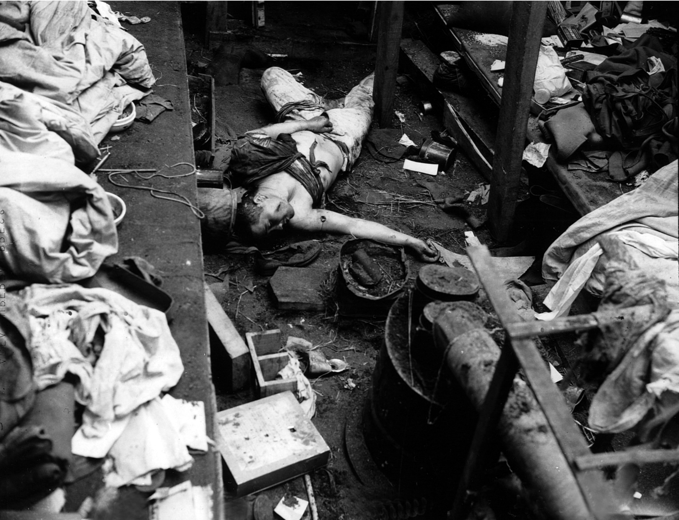 The body of a Japanese soldier who fought to the death lies sprawled on the floor of his bunker at Holtz Bay on the island of Attu. The soldier had been previously wounded as evidenced by old bandages.