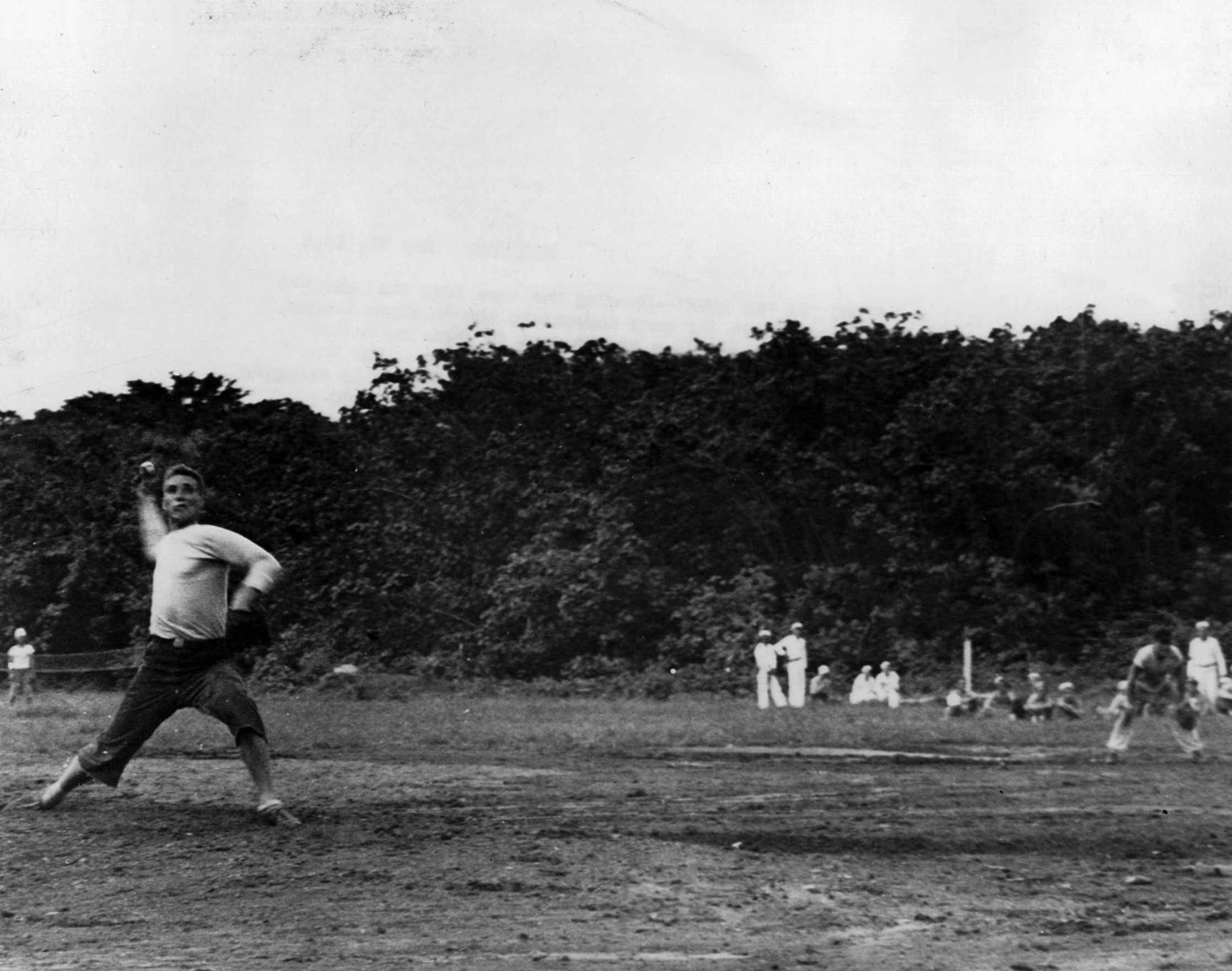 Bob Feller, a star pitcher with the Cleveland Indians, strides toward the plate and prepares to release the ball. Feller became a physical training instructor in the military in the spring of 1944. 