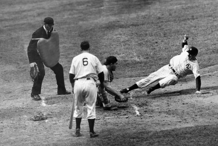 Joe Dimaggio, the famed Yankee Clipper, steals home during a game against the Chicago White Sox in May 1942. Dimaggio set a record the previous season for his 56-game hitting streak.