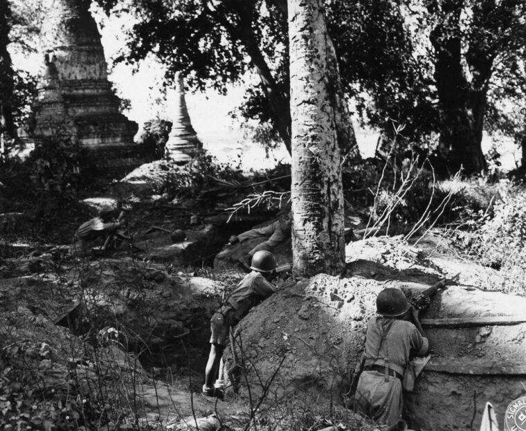 Keeping a sharp lookout for movement by the Japanese enemy, Chinese soldiers have taken cover in deep and lengthy trenches just beyond the Burmese frontier.