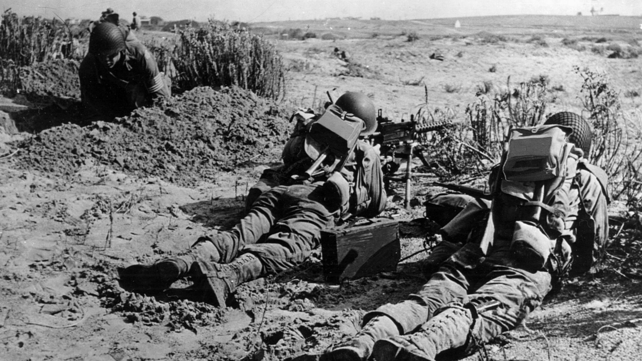 On November 10, 1942, American troops occupy a machine-gun position in North Africa. The troops met sporadic resistance from Vichy French forces.