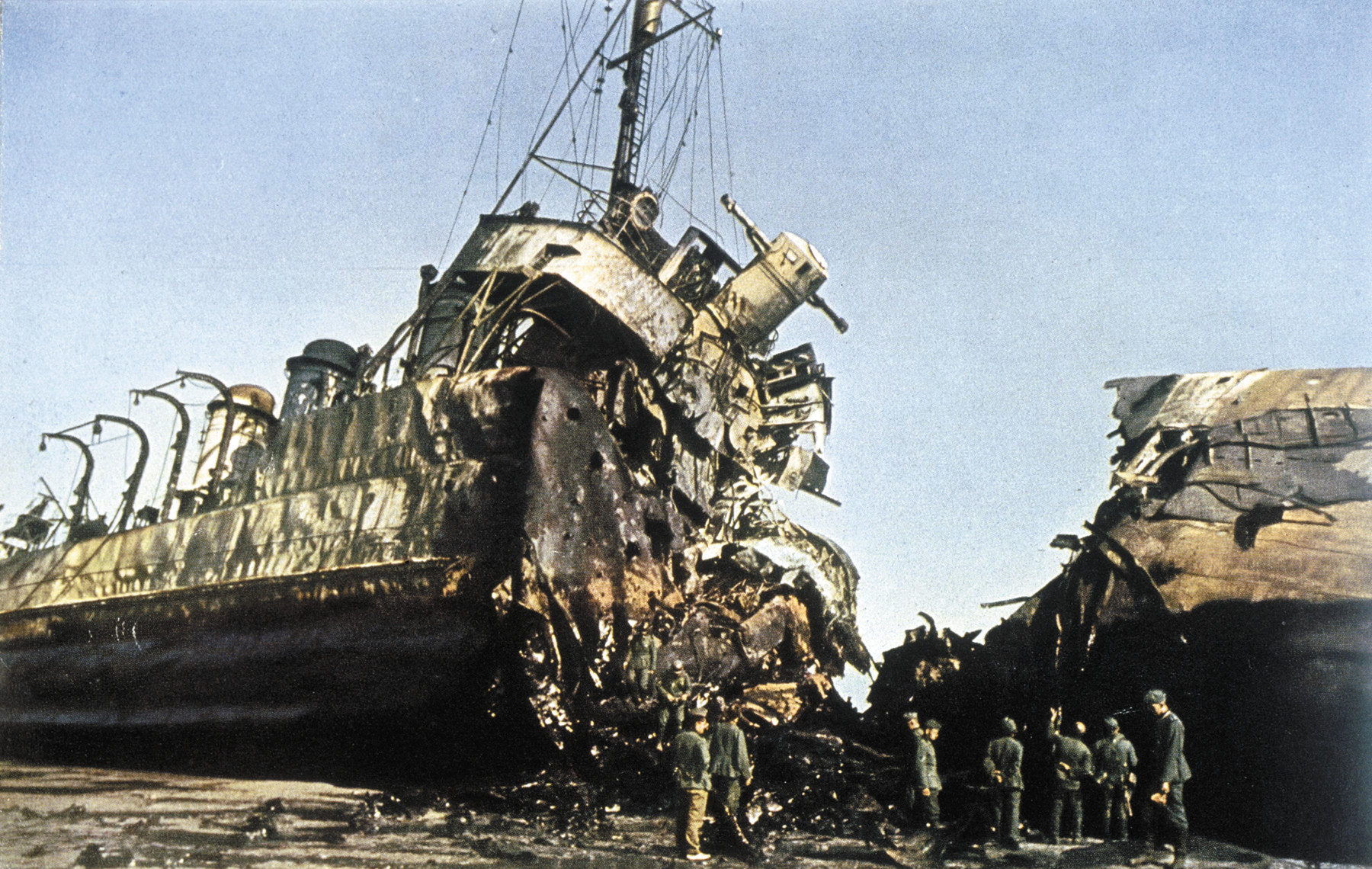 German soldiers inspect a British vessel destroyed by the Luftwaffe at Dunkirk. A direct hit by a bomb has blown the ship in half. 
