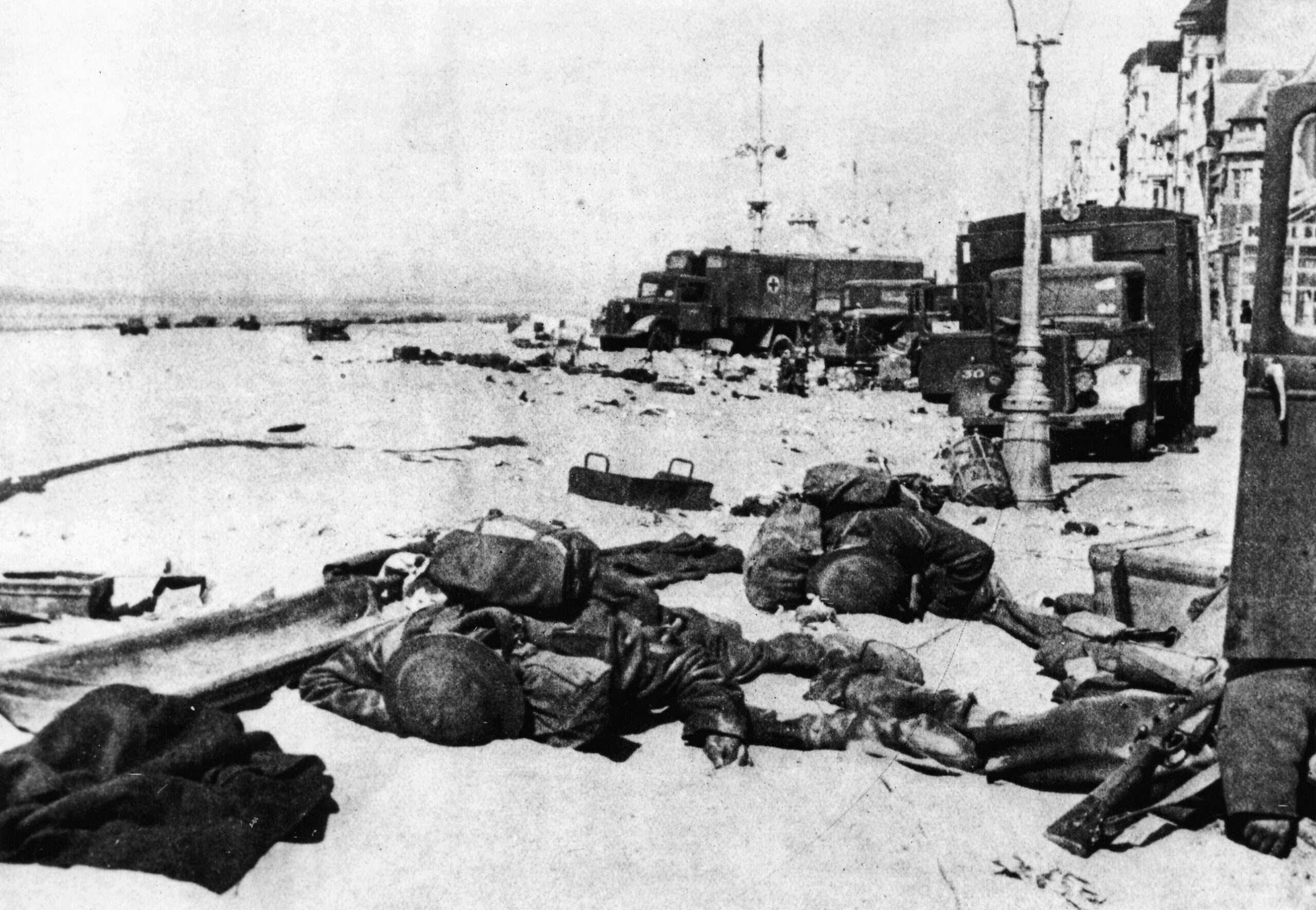 The bodies of two British soldiers, who were not as fortunate as many of their comrades, lie unburied amid abandoned equipment on the beach at Dunkirk. 