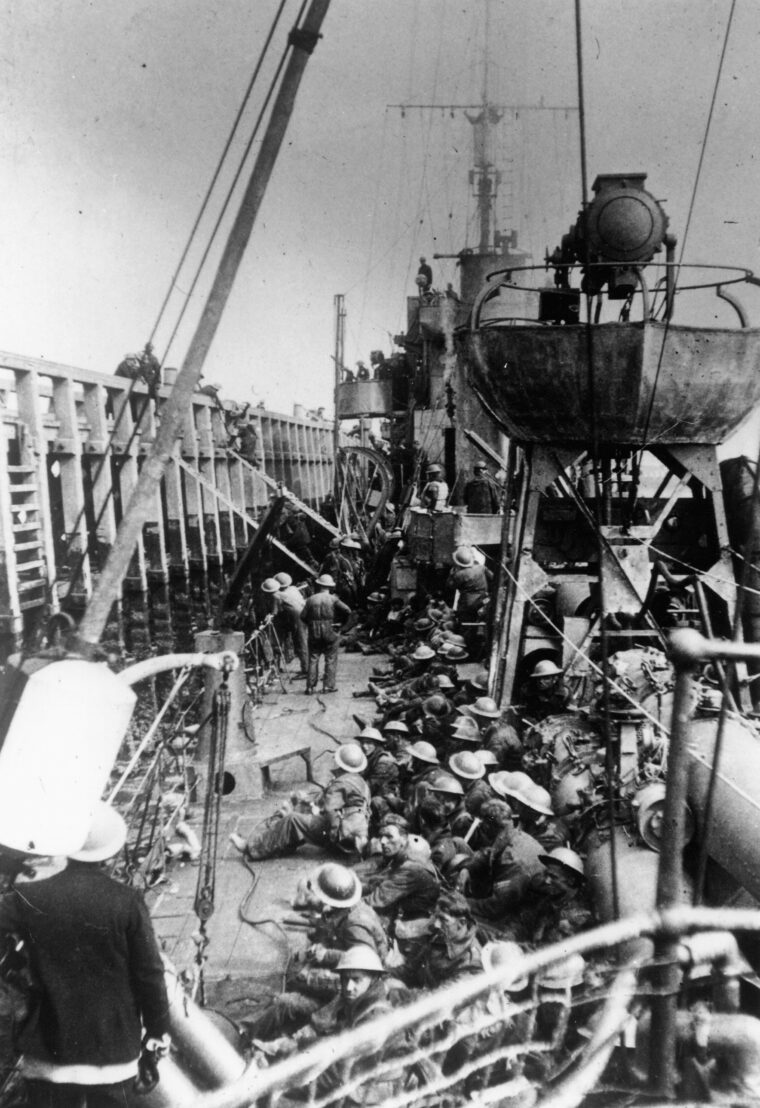British soldiers crowd the deck of a Royal Navy destroyer as they leave the mole at Dunkirk Beach for the perilous journey to England. 