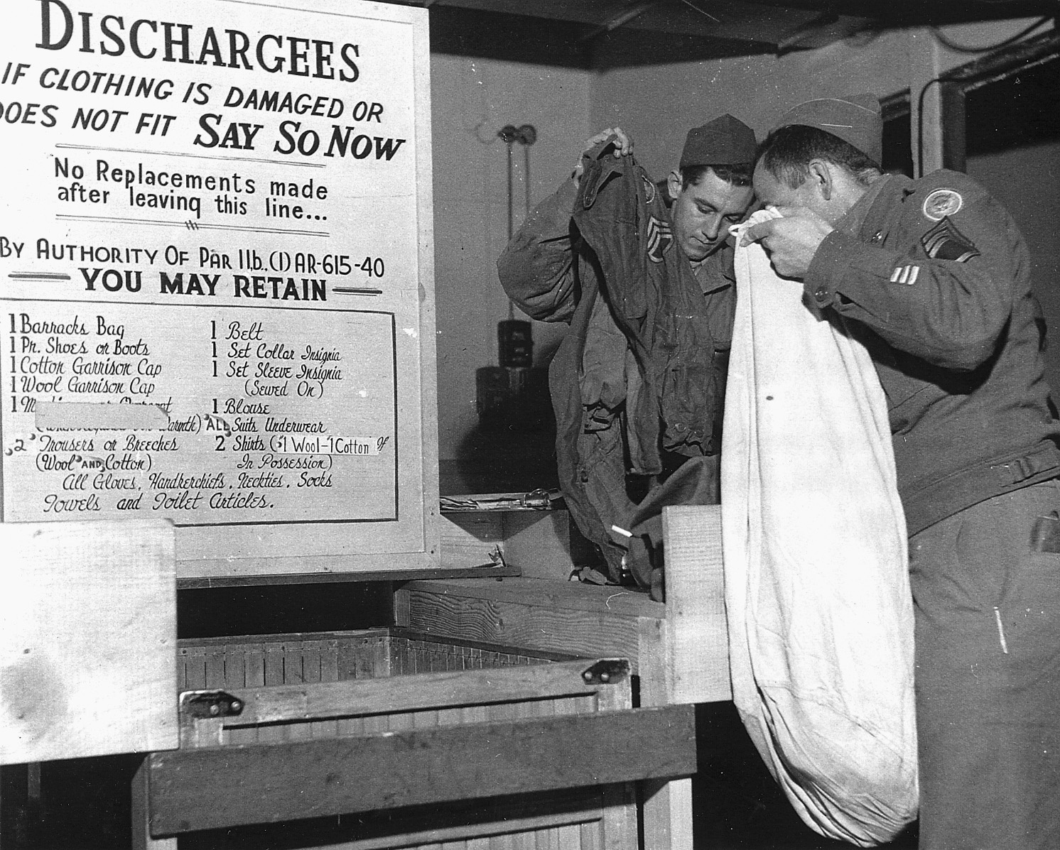 Turning in excess clothing is the next step. The place card tells him what he can keep. (Marines were allowed to keep their blankets.) A new uniform is issued to replace worn garments.