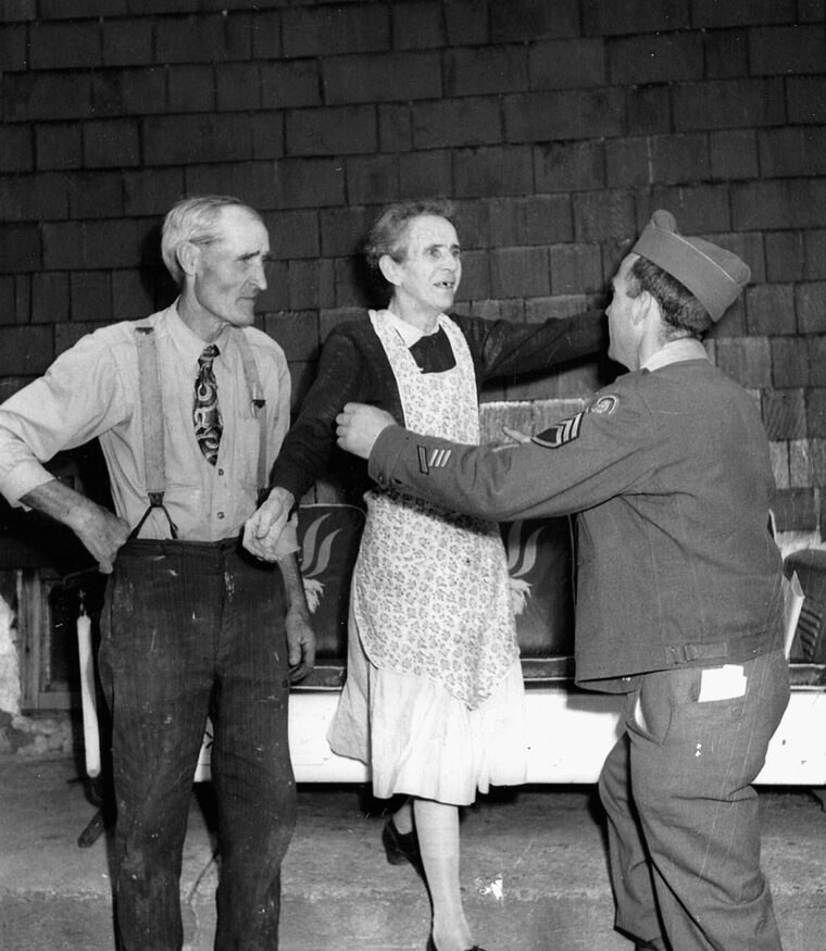 Home! Faulkner finds his mother and father waiting for him as he steps onto the front porch.